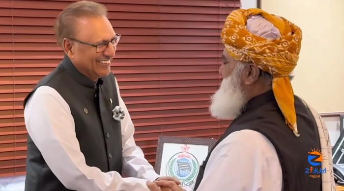 Alvi meets Fazl as PTI’s bid to block much-disputed constitutional amendment continues